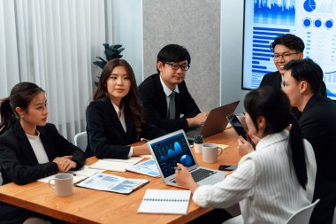 Business team of financial data analysis meeting with business intelligence, report paper and dashboard on laptop for marketing strategy. Business people working together to promote harmony in office.