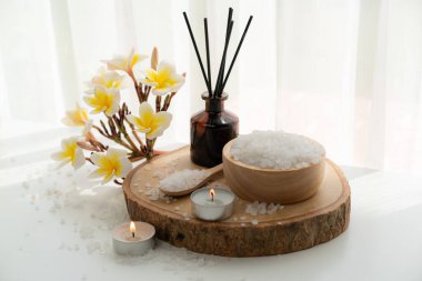 Spa accessory composition set in day spa hotel , beauty wellness center . Spa product are placed in luxury spa resort room , ready for massage therapy from professional service .