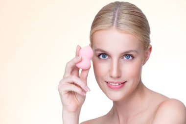 Personable beautiful natural soft makeup woman using powder puff for facial makeup concept. Cushion foundation applying on young girl face in isolated background.