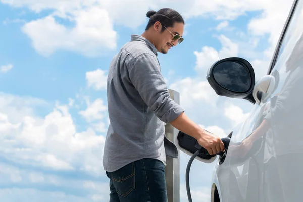 Progressive Man Electric Vehicle Cloudscape Background Car Driven Clean Renewable — Zdjęcie stockowe