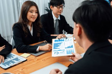 Business team of financial data analysis meeting with business intelligence, report paper and dashboard on laptop for marketing strategy. Business people working together to promote harmony in office.