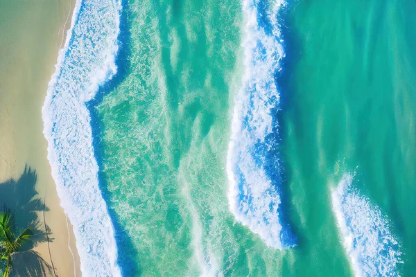 Spectacular top view from drone photo of beautiful beach with relaxing sunlight, sea water waves pounding the sand at the shore. Calmness and refreshing beach scenery.