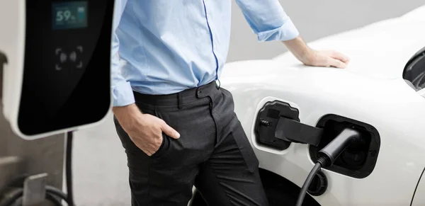Closeup Progressive Suit Clad Businessman His Electric Vehicle Recharge His — Stockfoto