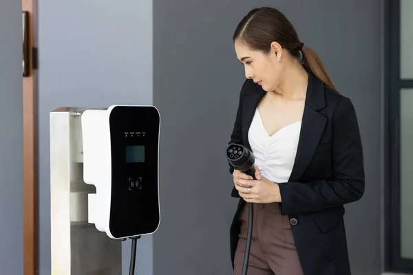 Asian Woman Holding Pointing Plug Home Charging Station Providing Sustainable — Foto Stock