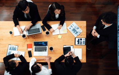 Top view manager or office worker give presentation in harmony conference room to business colleague, BI data dashboard on screen and pile of financial analyzed data reports on meeting table.