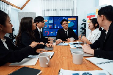 Business team of financial data analysis meeting with business intelligence, report paper and dashboard on laptop for marketing strategy. Business people working together to promote harmony in office.