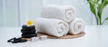 Spa accessory composition set in day spa hotel , beauty wellness center . Spa product are placed in luxury spa resort room , ready for massage therapy from professional service .