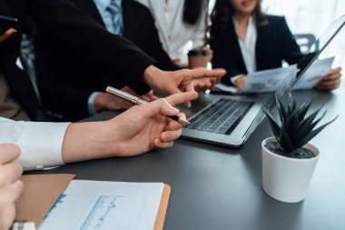 Business team analyze business analytic or business intelligence dashboard on laptop screen show graph and chart with statistic in harmony office. Analyst team meeting researching, planning strategy.