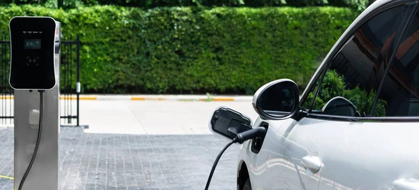Closeup Electric Vehicle Plugged Charger Public Charging Station Powered Renewable — Zdjęcie stockowe