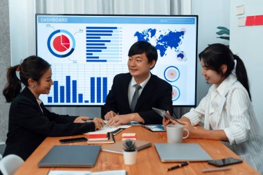 Business team of financial data analysis meeting with business intelligence, report paper and dashboard on laptop for marketing strategy. Business people working together to promote harmony in office.