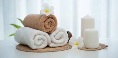 Spa accessory composition set in day spa hotel , beauty wellness center . Spa product are placed in luxury spa resort room , ready for massage therapy from professional service .