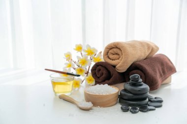 Spa accessory composition set in day spa hotel , beauty wellness center . Spa product are placed in luxury spa resort room , ready for massage therapy from professional service .