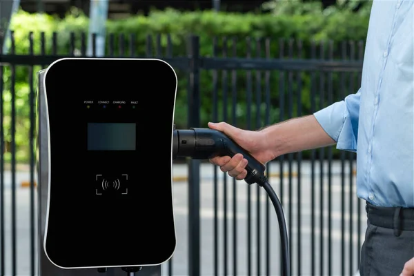 Closeup Progressive Man Holding Charger Plug Public Charging Station Electric — ストック写真