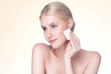 Personable beautiful natural soft makeup woman using powder puff for facial makeup concept. Cushion foundation applying on young girl face in isolated background.