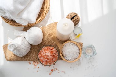 Spa accessory composition set in day spa hotel , beauty wellness center . Spa product are placed in luxury spa resort room , ready for massage therapy from professional service .