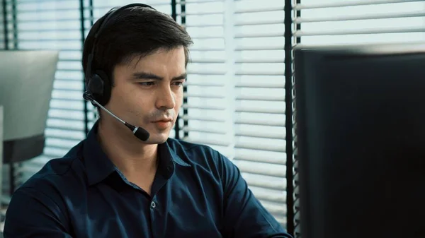 Young Competent Asian Male Call Center Agent Working His Computer — ストック写真