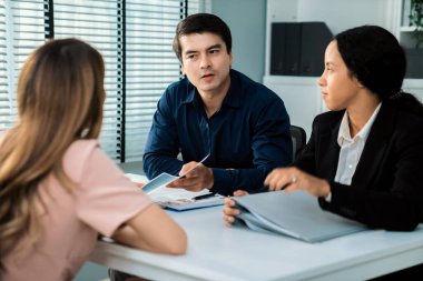 A young female asian candidate tries to impress her interviewer by being competent. International company, multicultural environment in workplace.