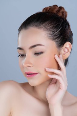 Glamorous woman portrait with perfect smooth pure clean skin with soft cosmetic makeup in isolated background. Beauty hand gesture with expressive facial expression for skincare product or spa ad.