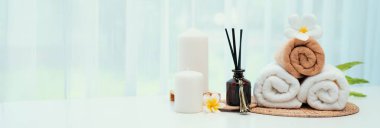 Spa accessory composition set in day spa hotel , beauty wellness center . Spa product are placed in luxury spa resort room , ready for massage therapy from professional service .