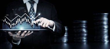 Businessman analyst working with digital finance business data graph showing technology of investment strategy for perceptive financial business decision. Digital economic analysis technology concept.