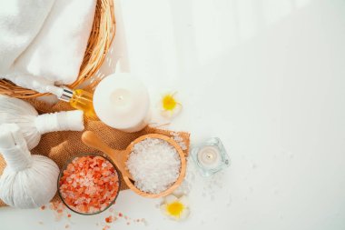 Spa accessory composition set in day spa hotel , beauty wellness center . Spa product are placed in luxury spa resort room , ready for massage therapy from professional service .
