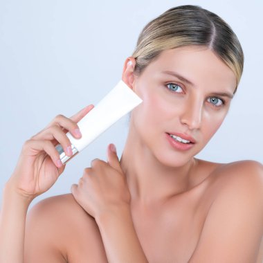 Alluring beautiful perfect cosmetic skin woman portrait hold mockup tube cream or moisturizer for skincare treatment, anti-aging product in isolated background. Natural healthy skin model concept.