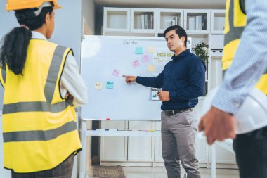 A team of investor and competent engineers brainstorming on the whiteboard to find new ideas and making plans. The idea of a team gather ideas together.