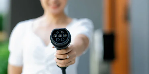 Focus Hand Holding Pointing Charger Plug Electric Vehicle Camera Blur — Foto Stock