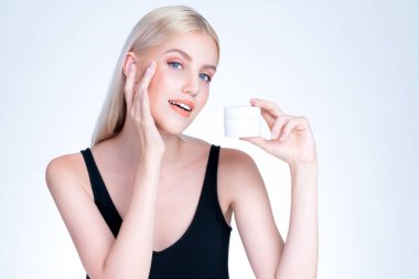 Personable beautiful perfect natural cosmetic makeup skin woman holding mockup jar moisturizer cream for healthy skincare treatment, anti-aging product advertisement in isolated background.