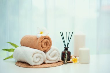 Spa accessory composition set in day spa hotel , beauty wellness center . Spa product are placed in luxury spa resort room , ready for massage therapy from professional service .