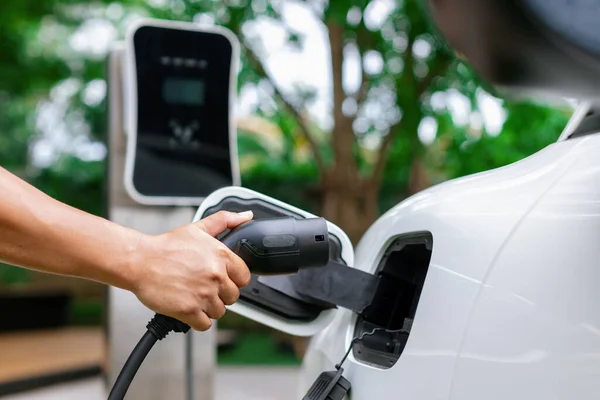 Hand Inserting Charging Plug Electric Vehicle Focus Shot Blurred Background — Fotografia de Stock