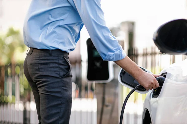 Closeup Progressive Man Holding Charger Plug Public Charging Station Electric — Foto de Stock