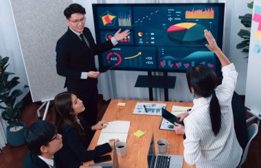 Confidence and asian businessman give presentation on financial analyzed by business intelligence in dashboard report to other people in board room meeting to promote harmony in workplace.