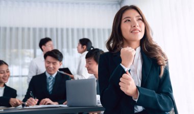 Focus portrait of female manger, businesswoman in the harmony meeting room with blurred of colleagues working together, analyzing financial paper report and dashboard data in background.