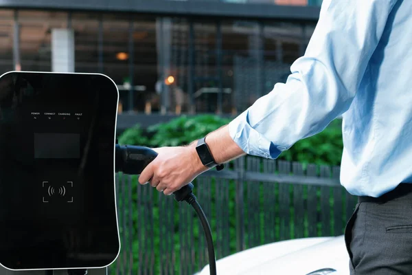 Closeup Progressive Man Holding Charger Plug Public Charging Station Electric — стоковое фото