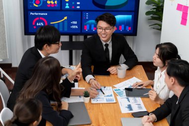 Business team of financial data analysis meeting with business intelligence, report paper and dashboard on laptop for marketing strategy. Business people working together to promote harmony in office.