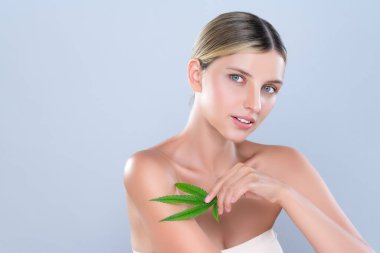 Alluring beautiful woman model portrait holding green leaf as concept for cannabis skincare cosmetic product for skin freshness treatment in isolated background.