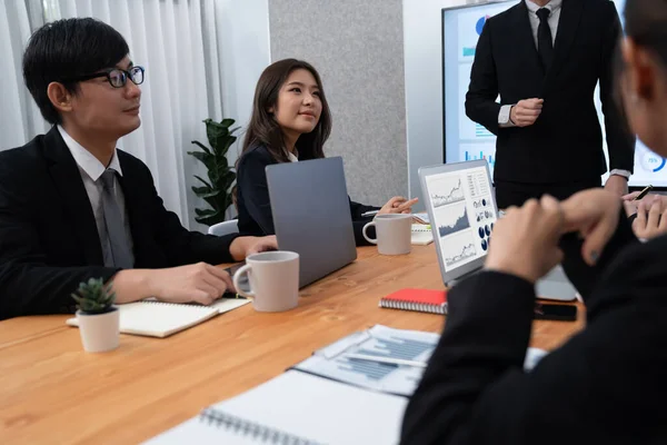 stock image Confidence and asian businessman give presentation on financial analyzed by business intelligence in dashboard report to other people in board room meeting to promote harmony in workplace.