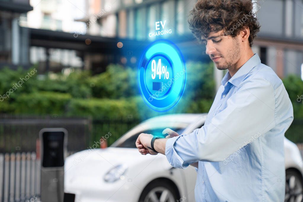 Progressive businessman check wearable hologram watch on electric car