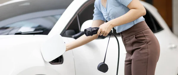 Closeup Progressive Woman Install Cable Plug Her Electric Car Home — Foto de Stock