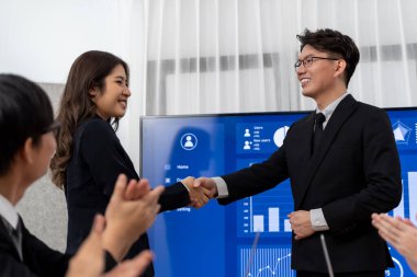 Businesspeople shake hand after successful agreement or meeting. Office worker colleague handshake with business team leader manager for strong teamwork in office to promote harmony and unity concept.