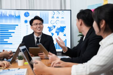 Business team of financial data analysis meeting with business intelligence, report paper and dashboard on laptop for marketing strategy. Business people working together to promote harmony in office.