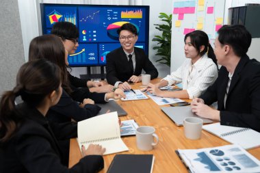 Business team of financial data analysis meeting with business intelligence, report paper and dashboard on laptop for marketing strategy. Business people working together to promote harmony in office.