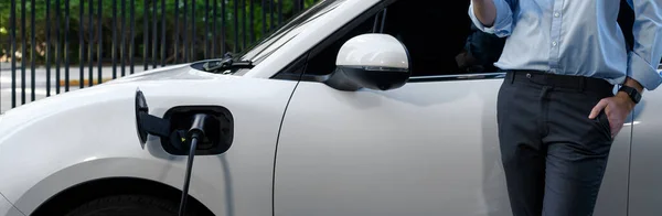 Closeup Progressive Suit Clad Businessman His Electric Vehicle Recharge His — Stockfoto