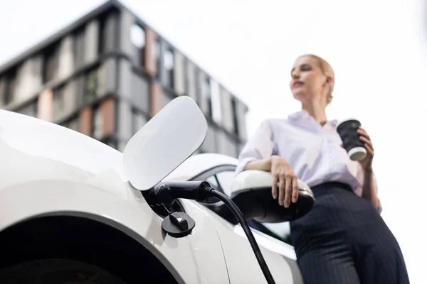 Progressive Businesswoman Electric Car Charging Station Driving City Center Eco — Foto Stock