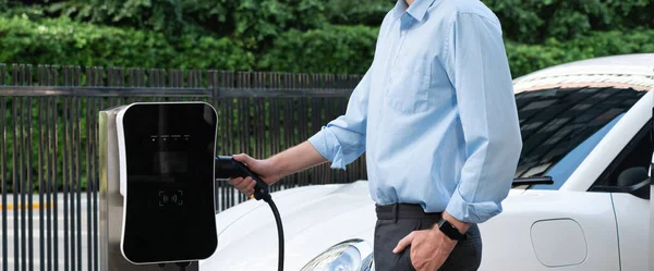 Closeup Progressive Man Holding Charger Plug Public Charging Station Electric — Stock fotografie