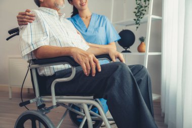 Caring nurse and a contented senior man in a wheel chair at home, nursing house. Medical for elderly patient, home care for pensioners.