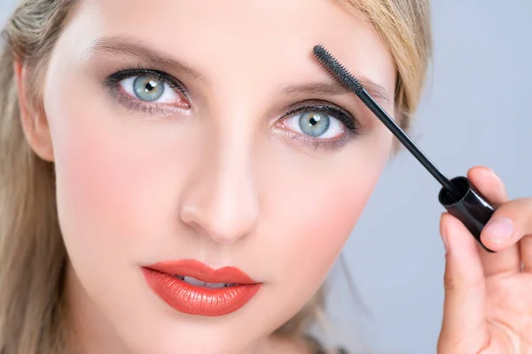 Closeup Woman Blond Hair Putting Alluring Black Mascara Brush Hand — Photo