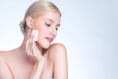 Personable beautiful natural soft makeup woman using powder puff for facial makeup concept. Cushion foundation applying on young girl face in isolated background.