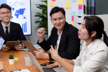 Business team of financial data analysis meeting with business intelligence, report paper and dashboard on laptop for marketing strategy. Business people working together to promote harmony in office.